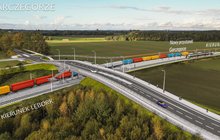 W centralnej części jest wiadukt drogowy nad torami, którymi jedzie pociąg towarowy. Po prawej stronie jest peron przystanku Garczegorze - PKP Polskie Linie Kolejowe S.A.