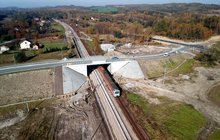 Pociąg przejeżdża pod wiaduktem w Woli Filipowskiej, widok z lotu ptaka, fot. Piotr Hamarnik