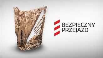 Statuetka PR Wings, obok logotyp Bezpieczny Przejazd