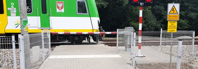 Pociąg jedzie przez przejazd prowadzący do Rezerwatu Olszynka Grochowska, fot. K. Mazurek