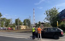 Przedstawiciel PLK SA i Straży Ochrony Kolei pouczają kierowcę na przejezdzie kolejowo-drogowym, fot. Anna Znajewska-Pawluk