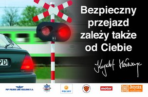 Plakat kampanii Bezpieczny przejazd z hasłem Bezpieczny przejazd zależy także od Ciebie, autograf K. Hołowczyca.